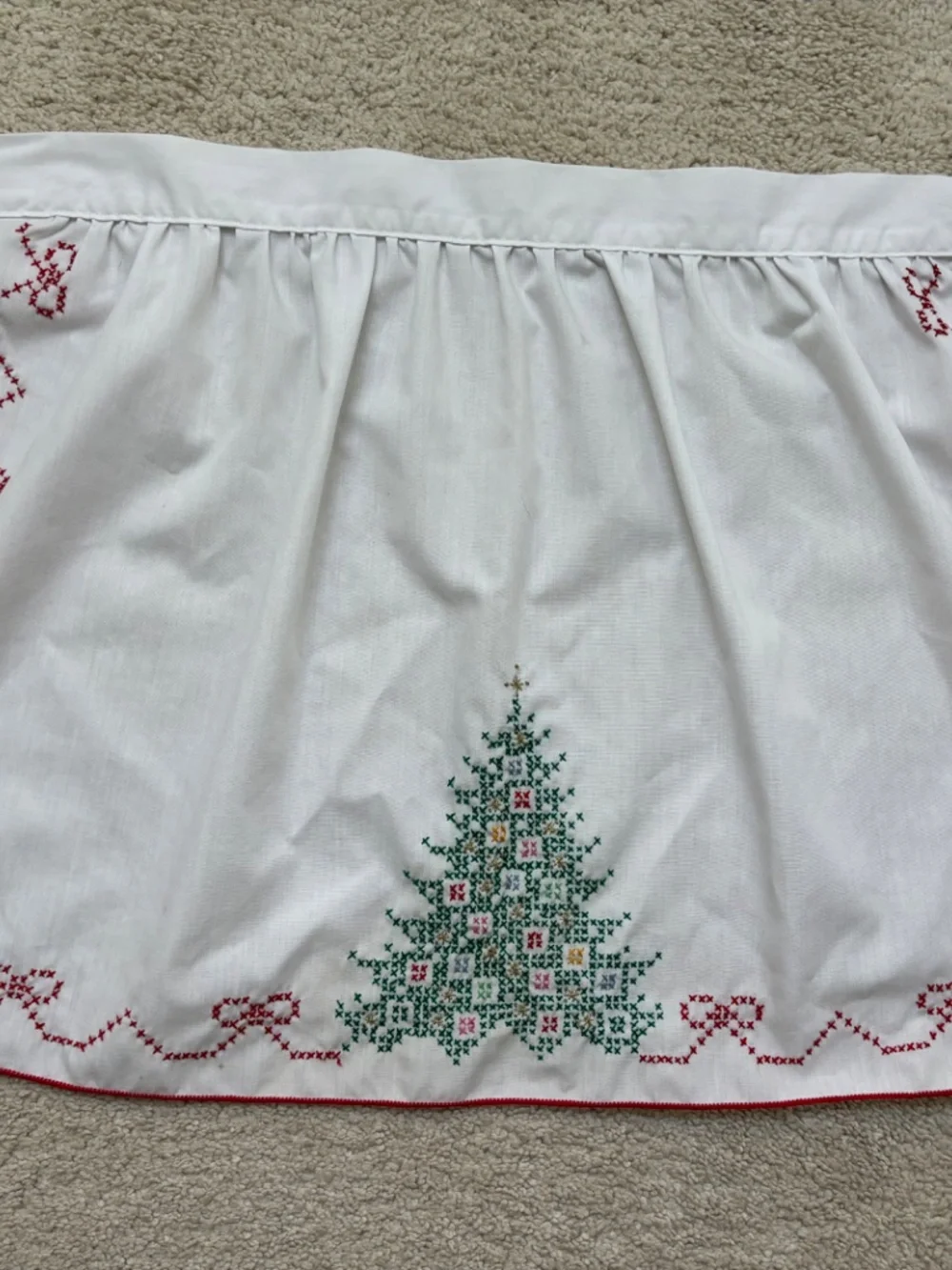 Vintage white half apron featuring hand-stitched cross-stitch Christmas trees